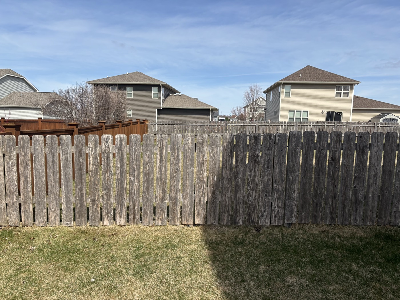 Weathered gray fence before cleaning and restoration